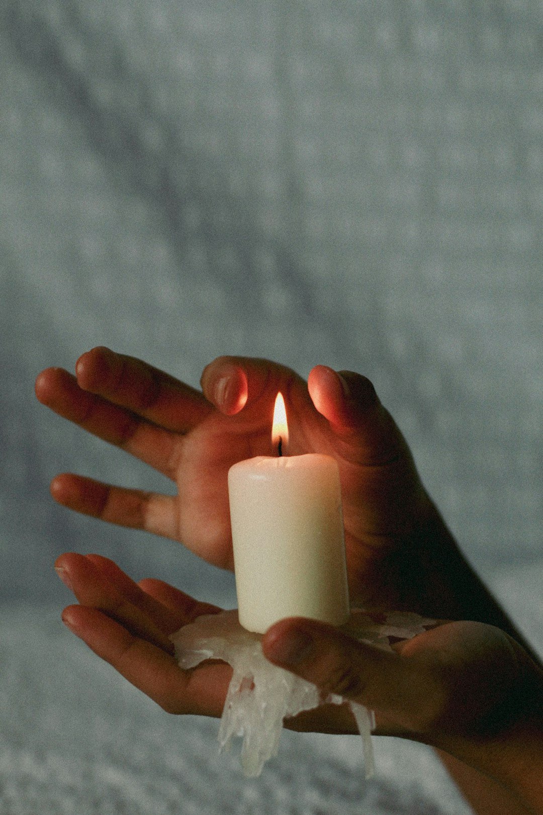 a-person-holding-a-lit-candle-in-their-hands-abfl9v9gphi